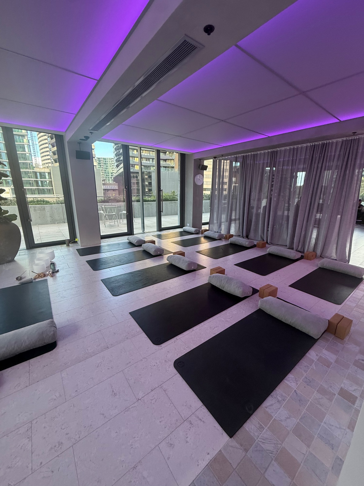 Yoga mats and bolsters set up for a group wellbeing session in a light-filled South Melbourne studio
