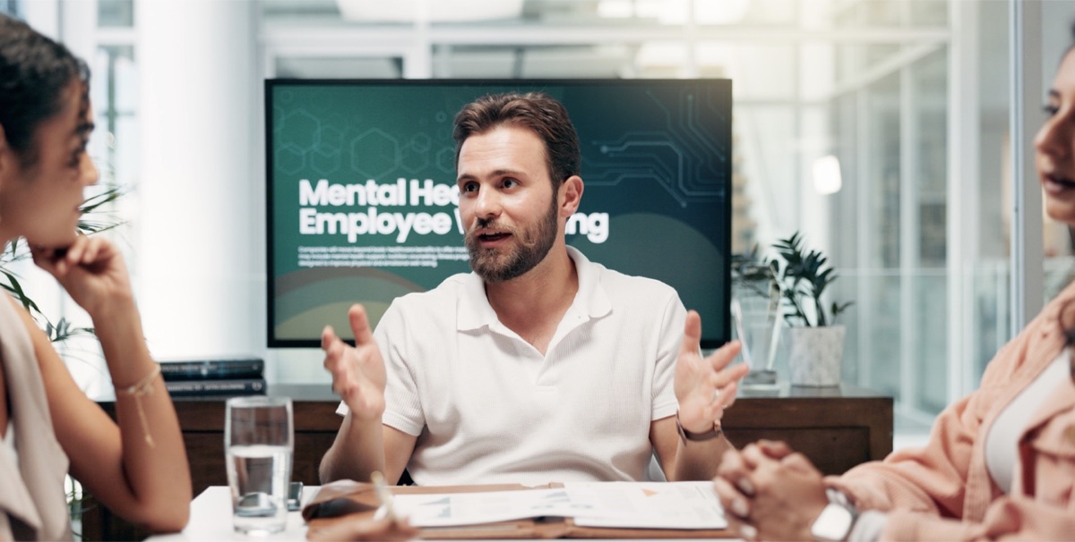 A team in a meeting discussing mental health and employee wellbeing