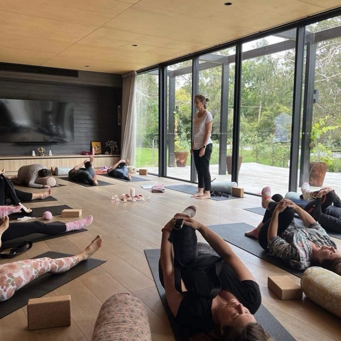 Kim Yates guiding a yoga class in a light-filled studio on the Mornington Peninsula